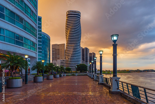 Cityscape of Guayaquil city at sunset with a view over the Malecon 2000 waterfront, the Guayas river and the point skyscraper after a thunderstorm, Ecuador. photo