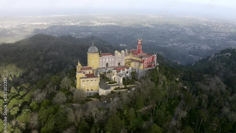 Aerial Spin: The Colorful Palace de Pena Castle at the Top of a hill in Portugal - Sintra, Portugal Aerial Spin: The Colorful Palace de Pena Castle at the Top of a hill in Portugal - Sintra, Portugal