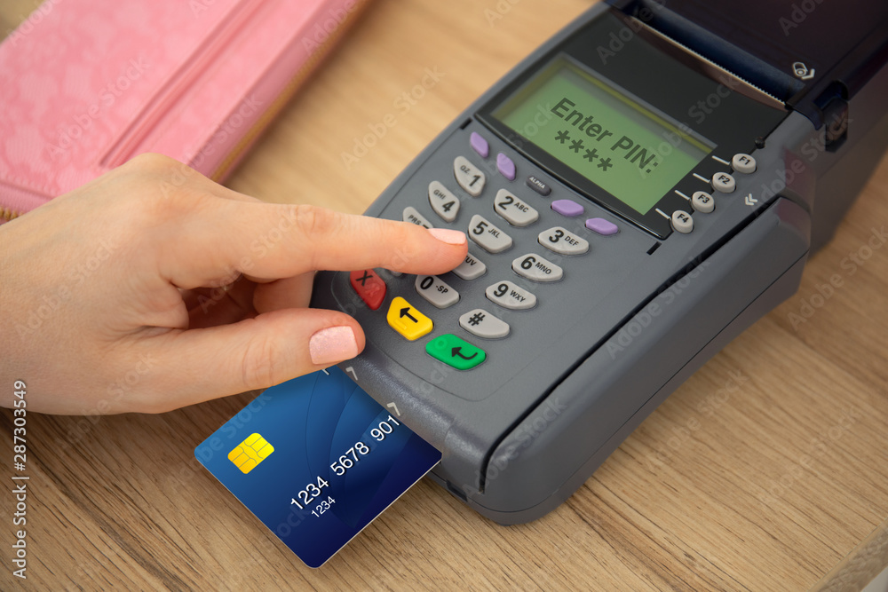 Woman hands holding plastic card and pay pass online terminal