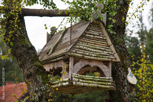 bird house hung on a tree © marcinmaslowski