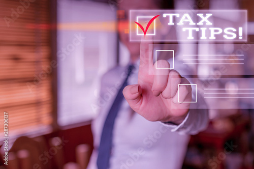 Word writing text Tax Tips. Business photo showcasing compulsory contribution to state revenue levied by government Woman standing Looking camera showing pointing the copy space bullet points