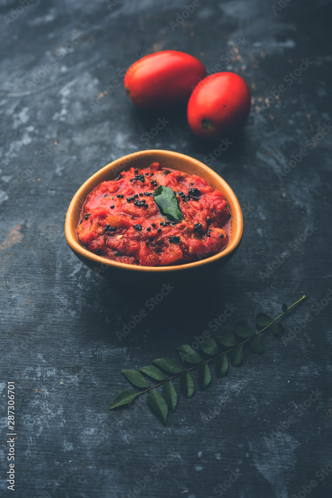 Tomato/tamatar chutney or sauce, served in a bowl. selective focus