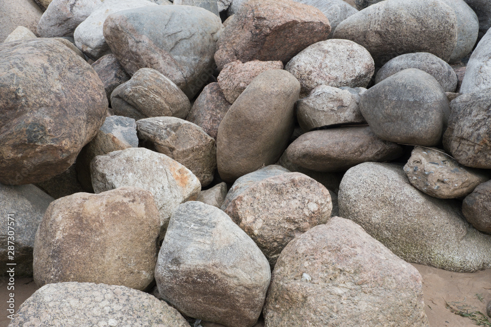Retaining wall made of stones, boulders. Stone of volcanic rocks, granite, basalt, gabro. Bank protection on the sea beach. Protection of the coast from destruction by waves. Waterworks. Retaining wall made of stones, boulders. Stone of volcanic rocks, granite, basalt, gabro. Bank protection on the sea beach. Protection of the coast from destruction by waves. Waterworks.