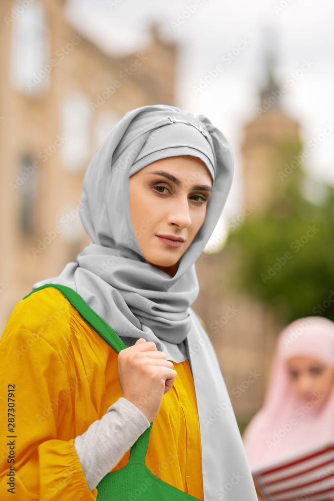 Beautiful young muslim woman standing near university Beautiful young muslim woman standing near university