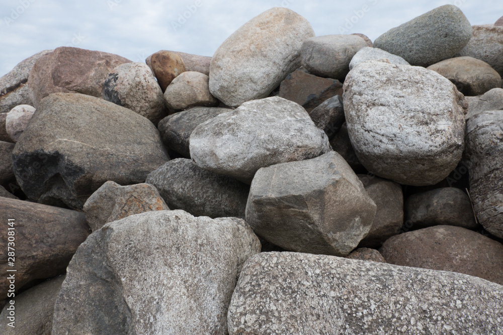Retaining wall made of stones, boulders. Stone of volcanic rocks, granite, basalt, gabro. Bank protection on the sea beach. Protection of the coast from destruction by waves. Waterworks. Retaining wall made of stones, boulders. Stone of volcanic rocks, granite, basalt, gabro. Bank protection on the sea beach. Protection of the coast from destruction by waves. Waterworks.