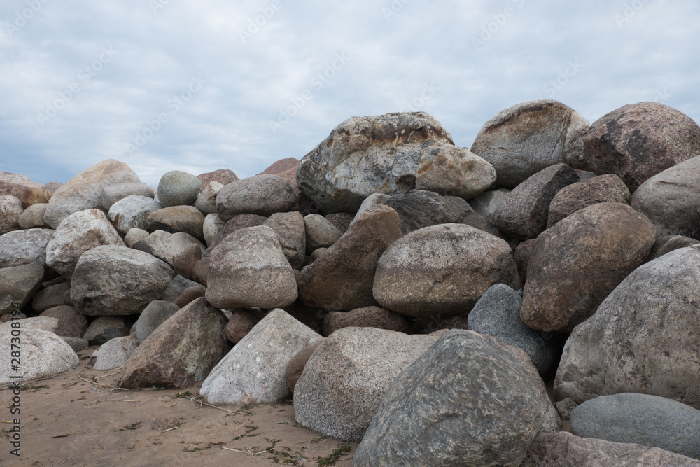 Retaining wall made of stones, boulders. Stone of volcanic rocks, granite, basalt, gabro. Bank protection on the sea beach. Protection of the coast from destruction by waves. Waterworks. Retaining wall made of stones, boulders. Stone of volcanic rocks, granite, basalt, gabro. Bank protection on the sea beach. Protection of the coast from destruction by waves. Waterworks.