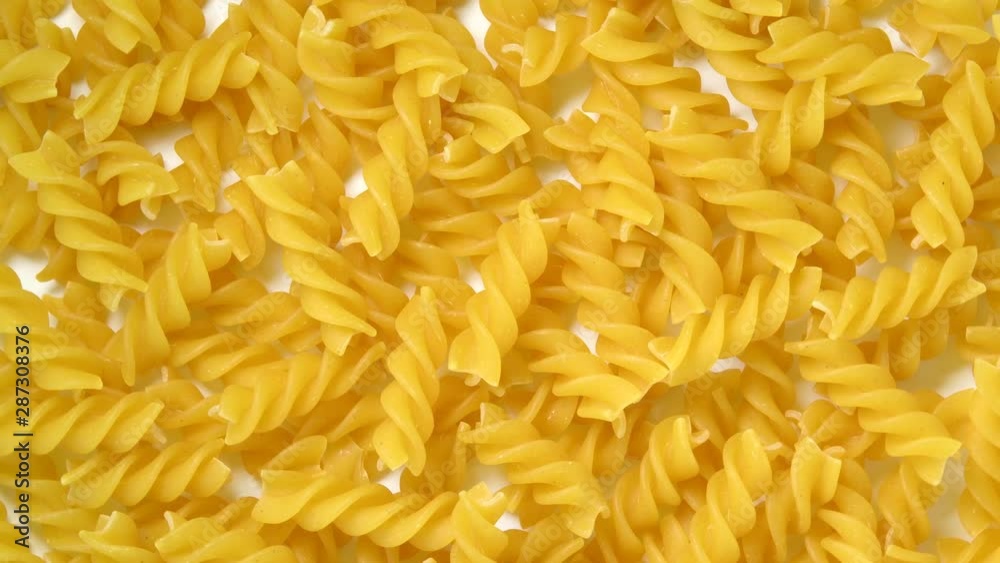 Uncooked fusilli pasta rotating top view Uncooked fusilli pasta rotating top view