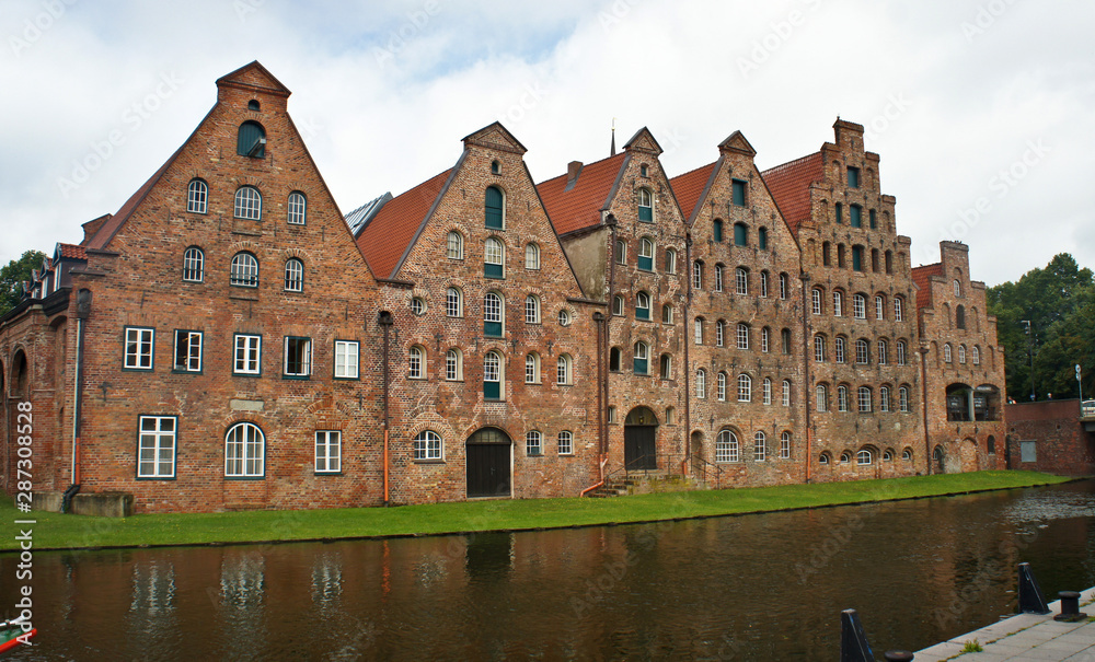 Beautiful view of Salzspeicher brick warehousesand river in old town, beautiful architecture, sunny day, Lubeck, Germany