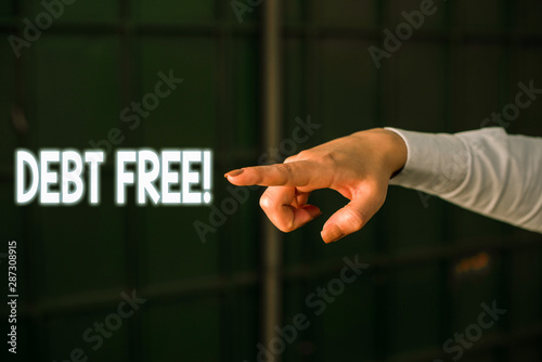 Text sign showing Debt Free. Business photo showcasing does not owning any money or things to any individual or companies Finger pointing in the Dark with hand pointing in the copy space