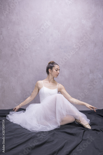 Front view young ballerina sitting