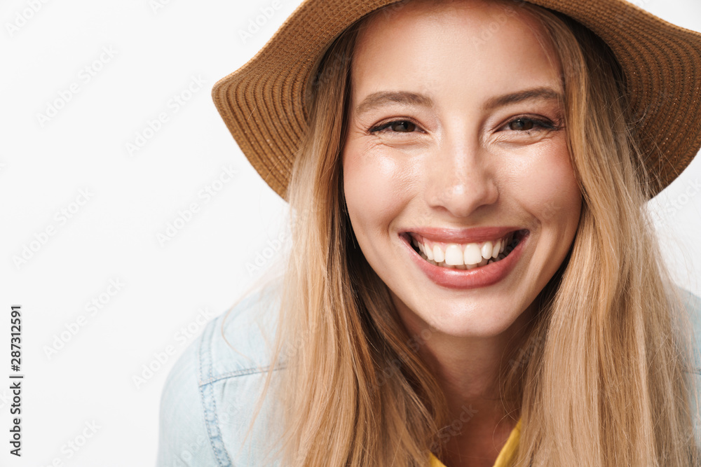 Happy smiling optimistic young pretty woman wearing hat posing isolated over white wall background. Happy smiling optimistic young pretty woman wearing hat posing isolated over white wall background.