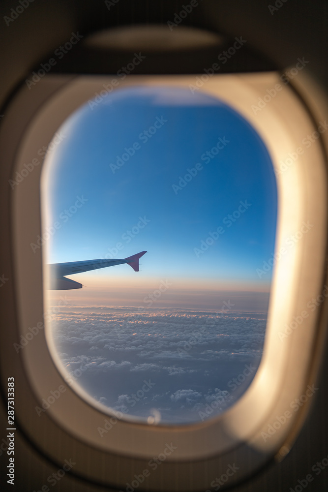 The window of the airplane. A view of porthole window on board an airbus for your travel concept or passenger air transportation The window of the airplane. A view of porthole window on board an airbus for your travel concept or passenger air transportation