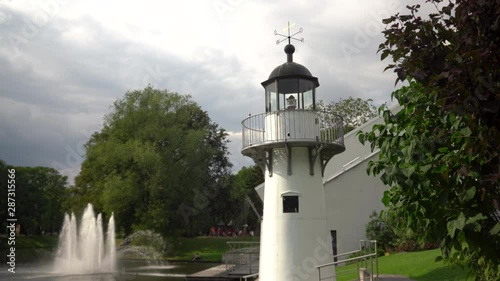 City canal with fountain and decorative lighthouse in Riga on a summer sunny day photo