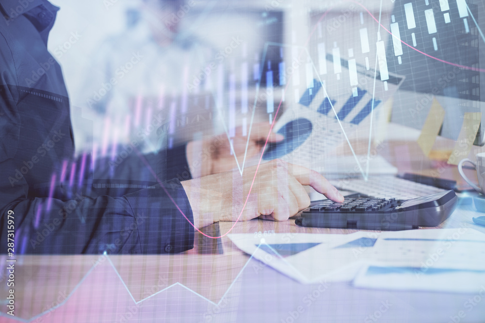 Double exposure of graph with man typing on computer in office on background. Concept of hard work. Closeup. Double exposure of graph with man typing on computer in office on background. Concept of hard work. Closeup.