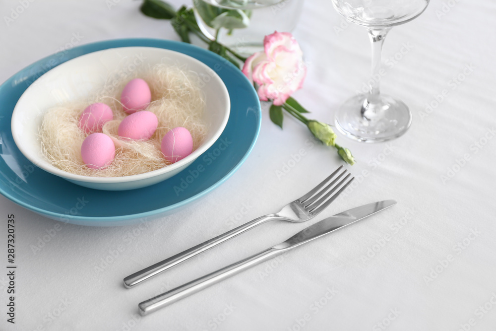Table setting for Easter celebration on white background