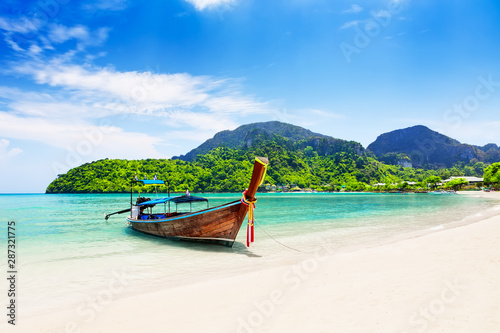 Thai traditional wooden longtail boat and beautiful sand beach. © preto_perola