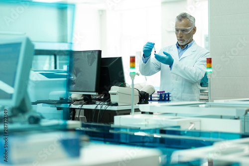 Concentrated senior male person working in laboratory