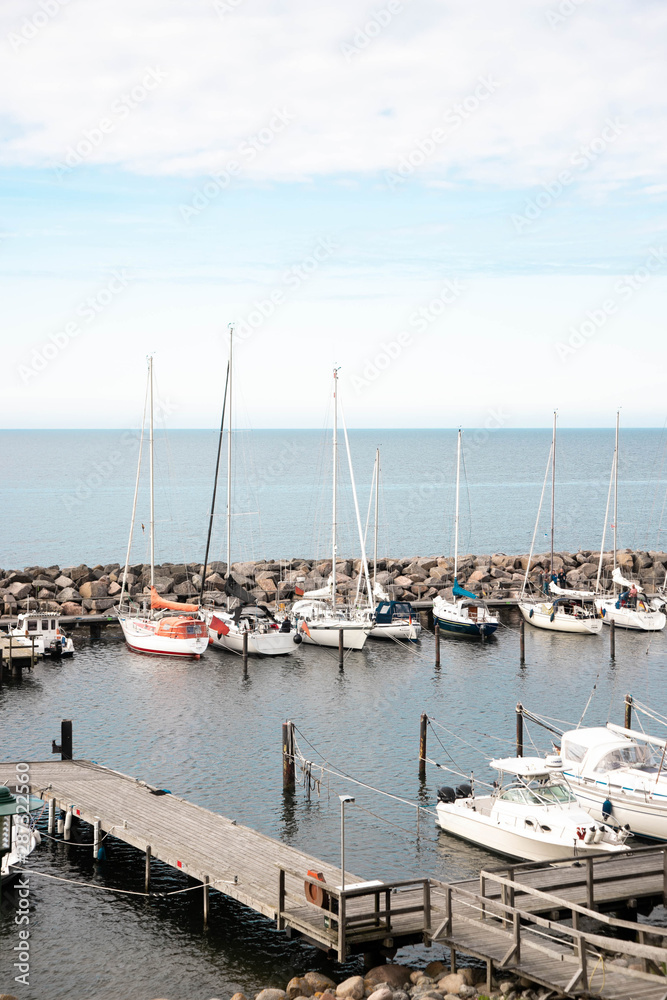 View of a small marina with fishing boats and yachts. Quiet harbor in the Baltic Sea