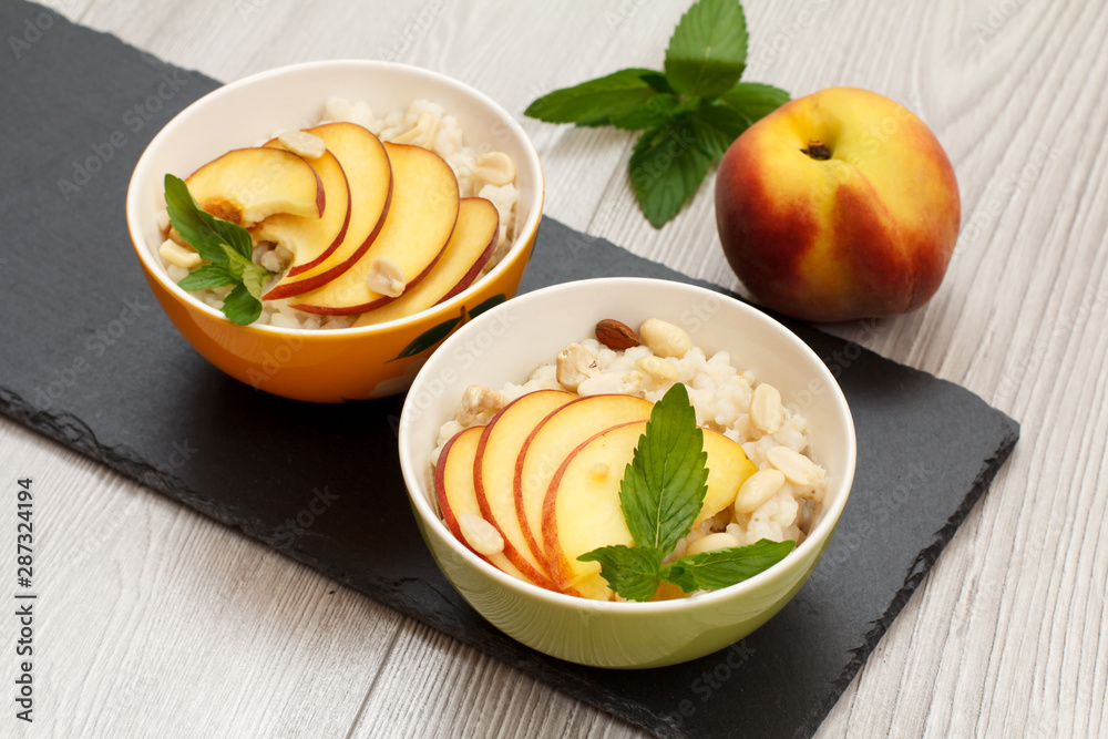 Sorghum salad with nuts and fresh peach on stone board. Sorghum salad with nuts and fresh peach on stone board.