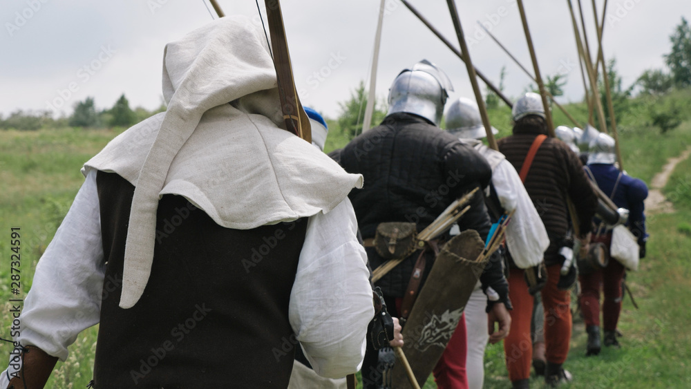 Back view of group medieval knights going on the battle. Back view of group medieval knights going on the battle.