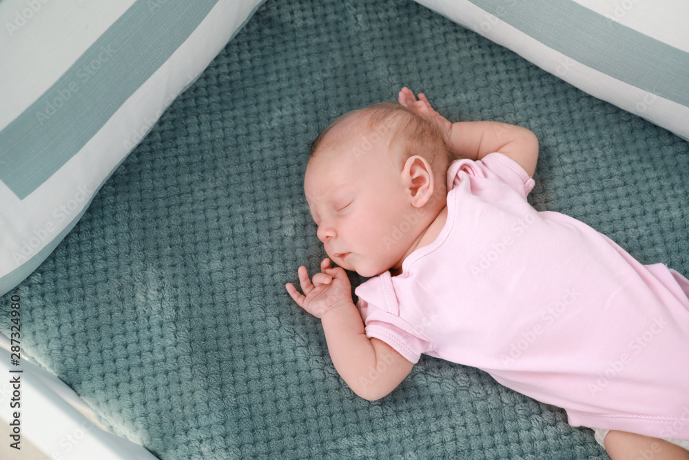 Cute little baby sleeping in crib - obrazy, fototapety, plakaty 