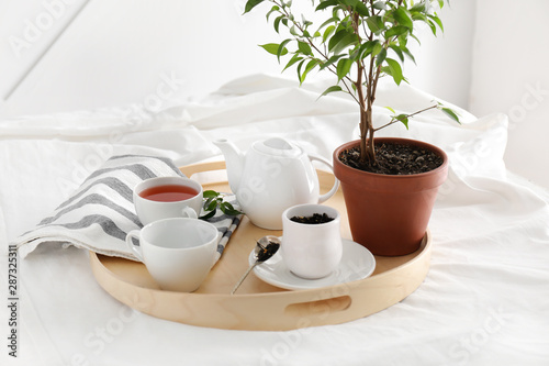 Tray with hot tea on bed in morning © Pixel-Shot