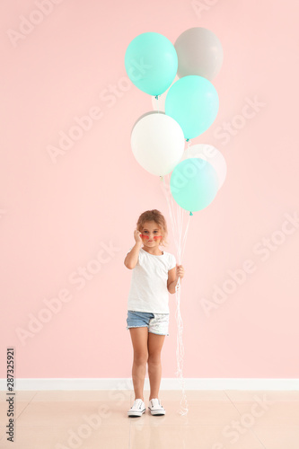 Little girl with balloons n...