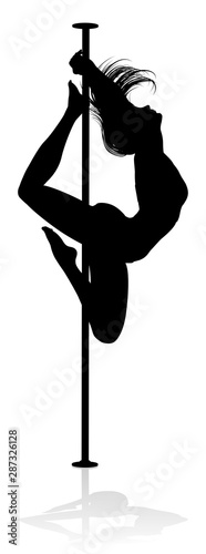 A woman pole dancer exercising for fitness in silhouette