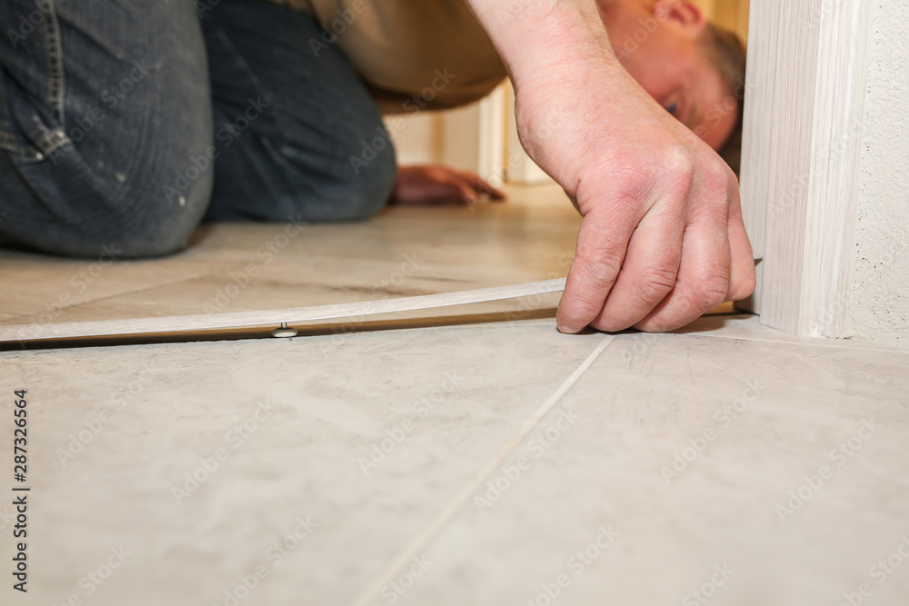 Installation of threshold indoors. Renovation works in the flat. Installation of threshold indoors. Renovation works in the flat.