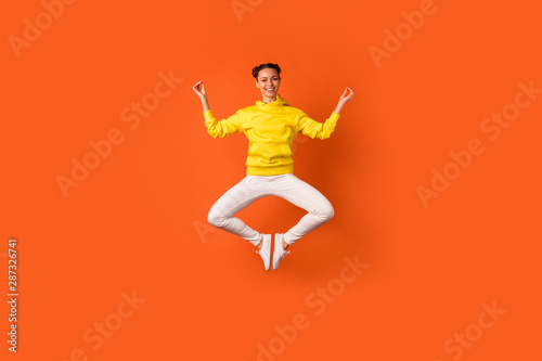 Full size photo of cheerful pretty lady doing exercise meditating showing om sign wear hood isolated over orange background