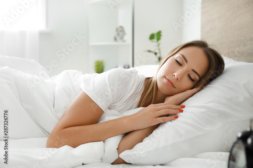 Morning of young woman sleeping in bed
