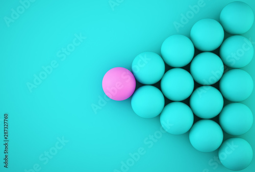 Abstract photo of ourstanding pink sphere among blue sphere on blue background. minimal business concept