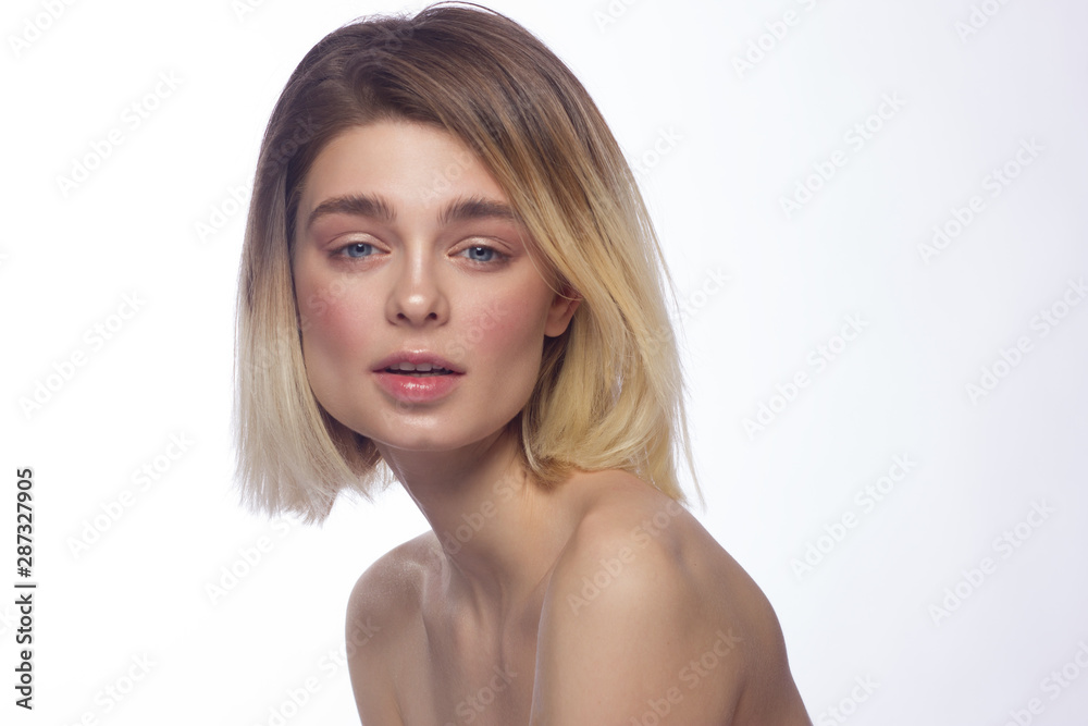 Close-up beautiful young woman face with clean perfect skin and hair. Portrait of beauty model with natural nude make up and hand near lips. Spa, skincare and wellness. Isolated on white background Close-up beautiful young woman face with clean perfect skin and hair. Portrait of beauty model with natural nude make up and hand near lips. Spa, skincare and wellness. Isolated on white background