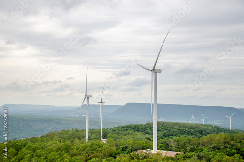 Aerial view of Wind turbine with hybrid tower on agricultural fields. Renewable energy production for green ecological world at Yai-Tiang hill,Thailand 