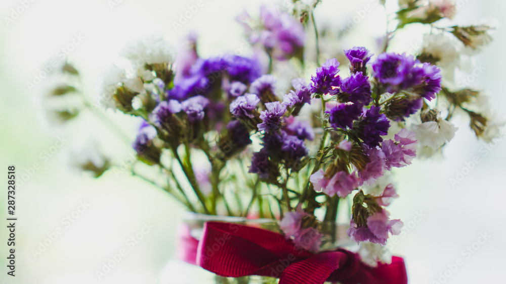 Bouquet of dried violet, pink and white wildflowers. Bright flowers lit by sunlight. Soft selective focus, macro flowers. Photo background. Bouquet of dried violet, pink and white wildflowers. Bright flowers lit by sunlight. Soft selective focus, macro flowers. Photo background.