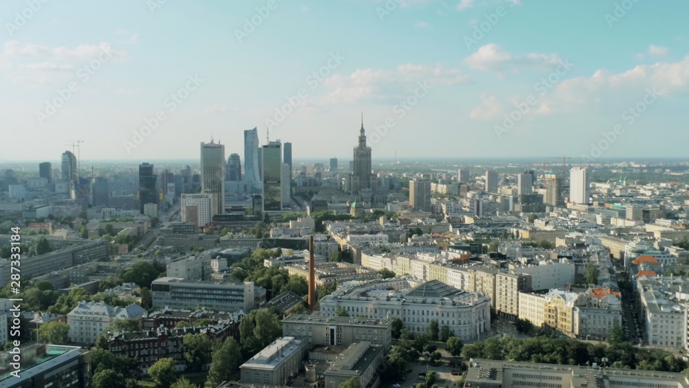 Fototapeta premium Aerial View of Warsaw City with Skyscrapers, Palace of Culture and Science and Office Buildings on Summer Day