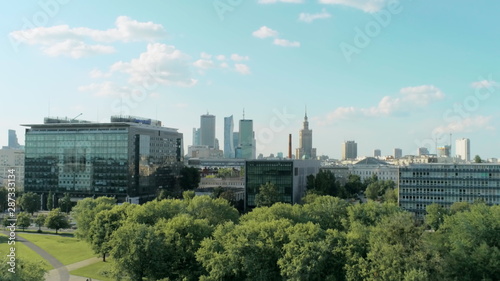 Aerial View of Warsaw City - Capital of Poland - with Skyscrapers, Palace of Culture and Science, Office Buildings and Green Park on Summer Day