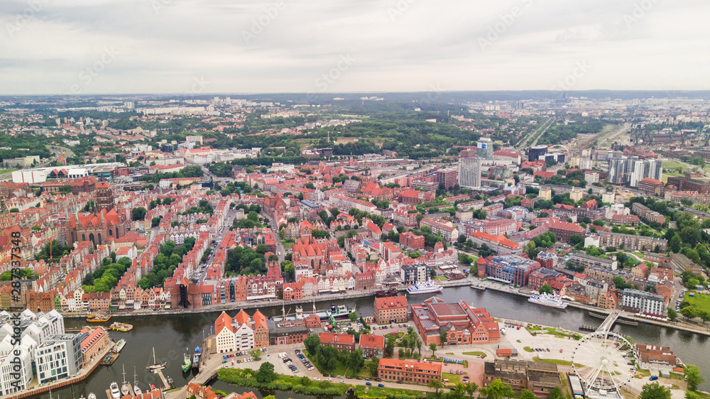 Gdansk, Poland. Aerial skyline panorama with Motlawa river, modern drawbridge, concert hall and all famous monuments in the background
