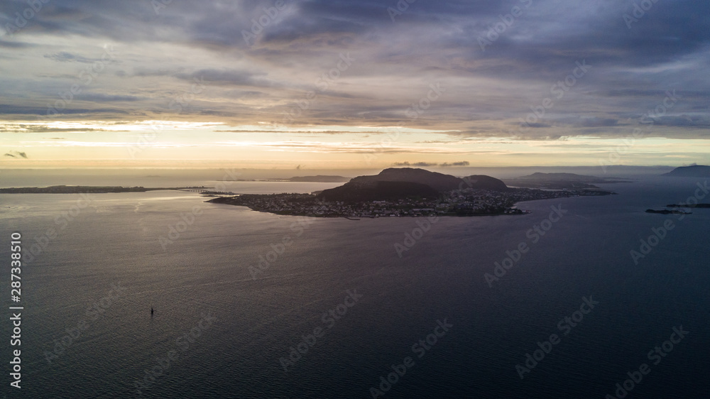 Alesund, Norway. Aerial view of Alesund, Norway at sunrise. Colorful sky over famous tourisitc destination with sunlight and mountains