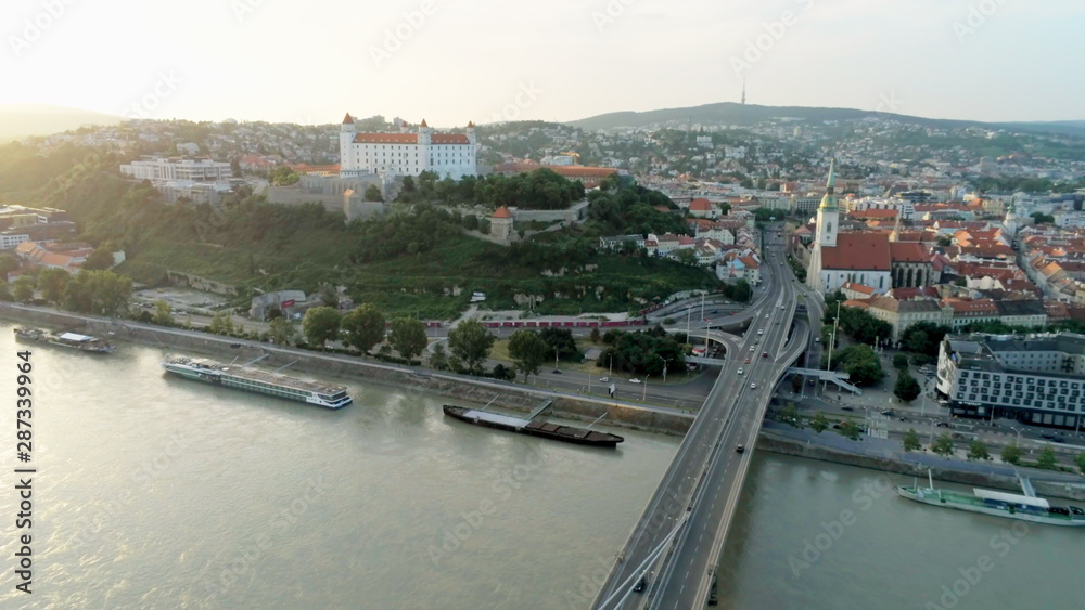 Bratislava Aerial Cityline (Slovakia): European Capital with Old Town, Castle, Church and Most SNP (Ufo Car Road Bridge) across Danube River at Sunset