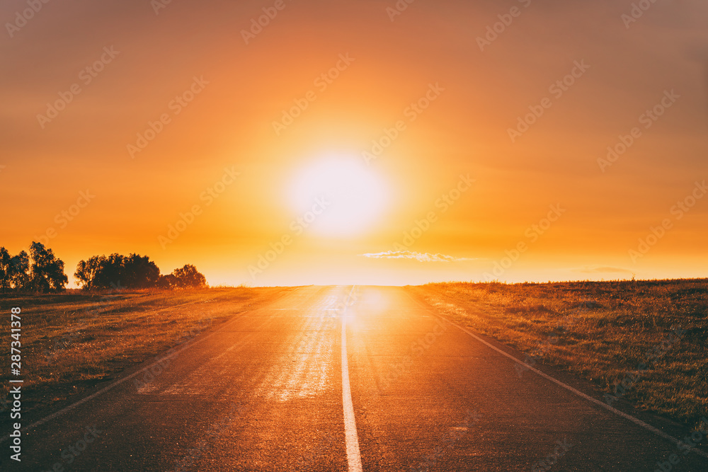 Sun Rising Above Asphalt Country Open Road In Sunny Sunrise Morning. Open Road In Summer Or Autumn Season At Sunny Sunset Evening