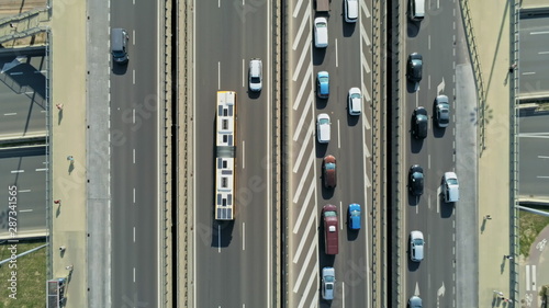 Transportation and Infrastructure: Highway Interchange and Junction with Cars, Trucks and Buses. Aerial View of Road Traffic Jam at Daytime Rush hour in Warsaw, Poland © OPEN FILMS