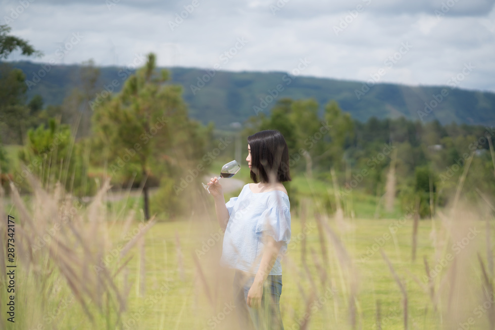 young cute Japanese Asian hipster girl drinking at beautiful sky  mountains scenery park garden views Kanchanaburi, Thailand. guiding  idea for female travelling happy rest relax woman women 