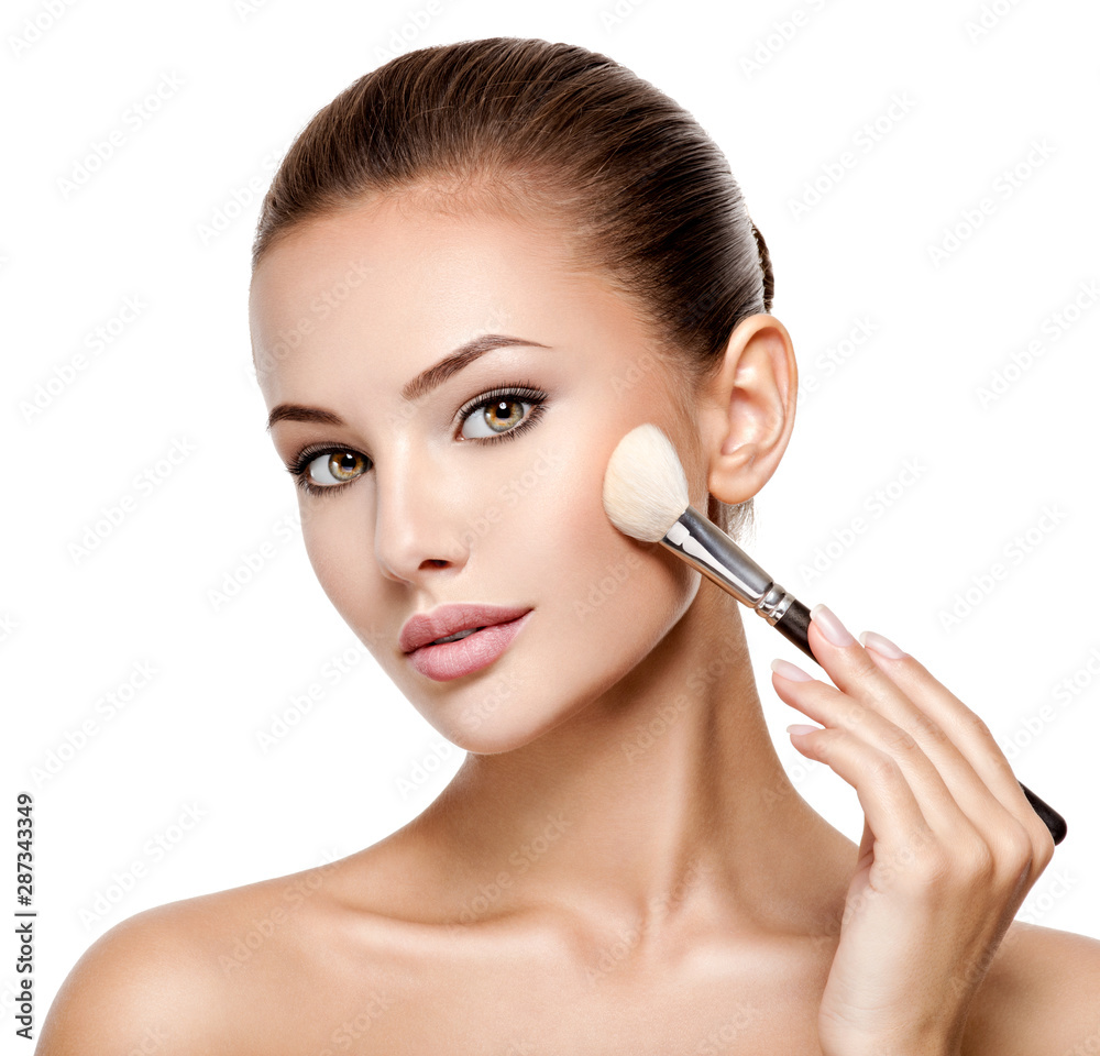 woman applying cosmetic makeup on the face with brush woman applying cosmetic makeup on the face with brush