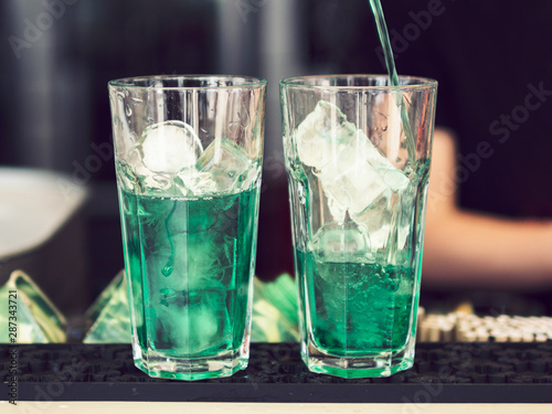 Glasses of colourful green beverage