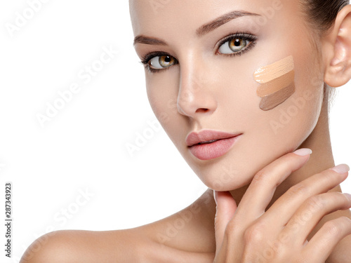 Fotografiet Beautiful face of  woman with cosmetic foundation on a skin.
