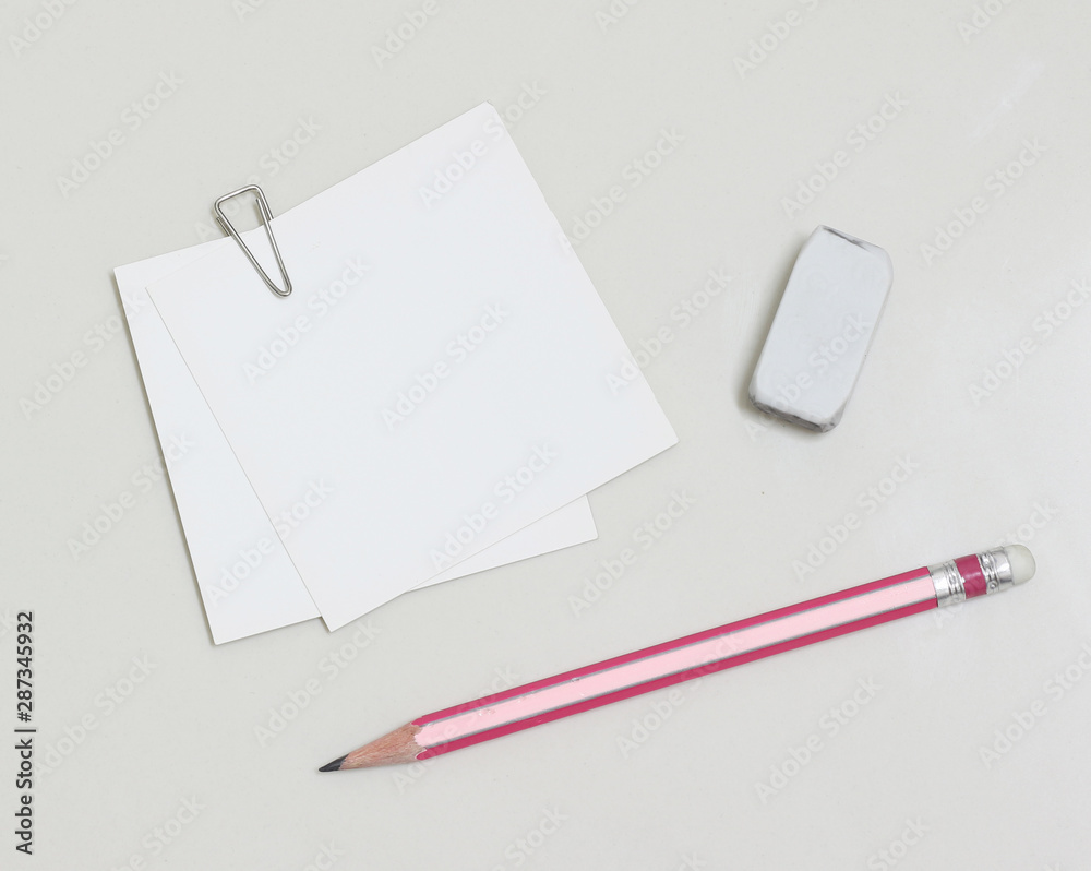 blank white paper with paperclip, pencil and eraser blank white paper with paperclip, pencil and eraser