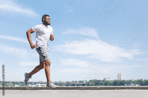 Black Man Jogging Outdoor Near River In City
