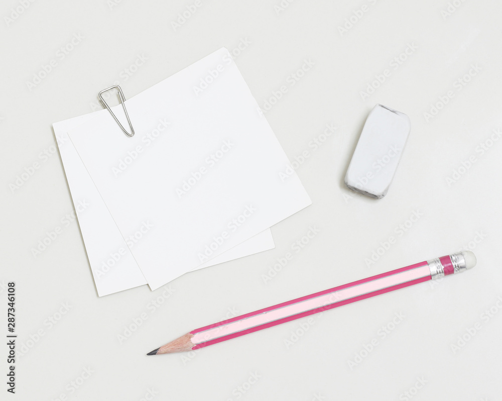 blank white paper with paperclip, pencil and eraser blank white paper with paperclip, pencil and eraser