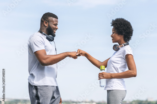 Afro Couple Giving Fist Bump After Morning Run Outdoor